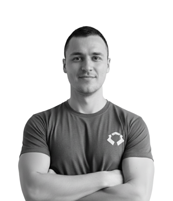 Black and white photo of a smiling professional man in a t-shirt. Black and white photo of a smiling professional man in a t-shirt on a purple gradient background. Text reads: 'Employers: Partnering with Game Studios & Growth-Focused Teams'.